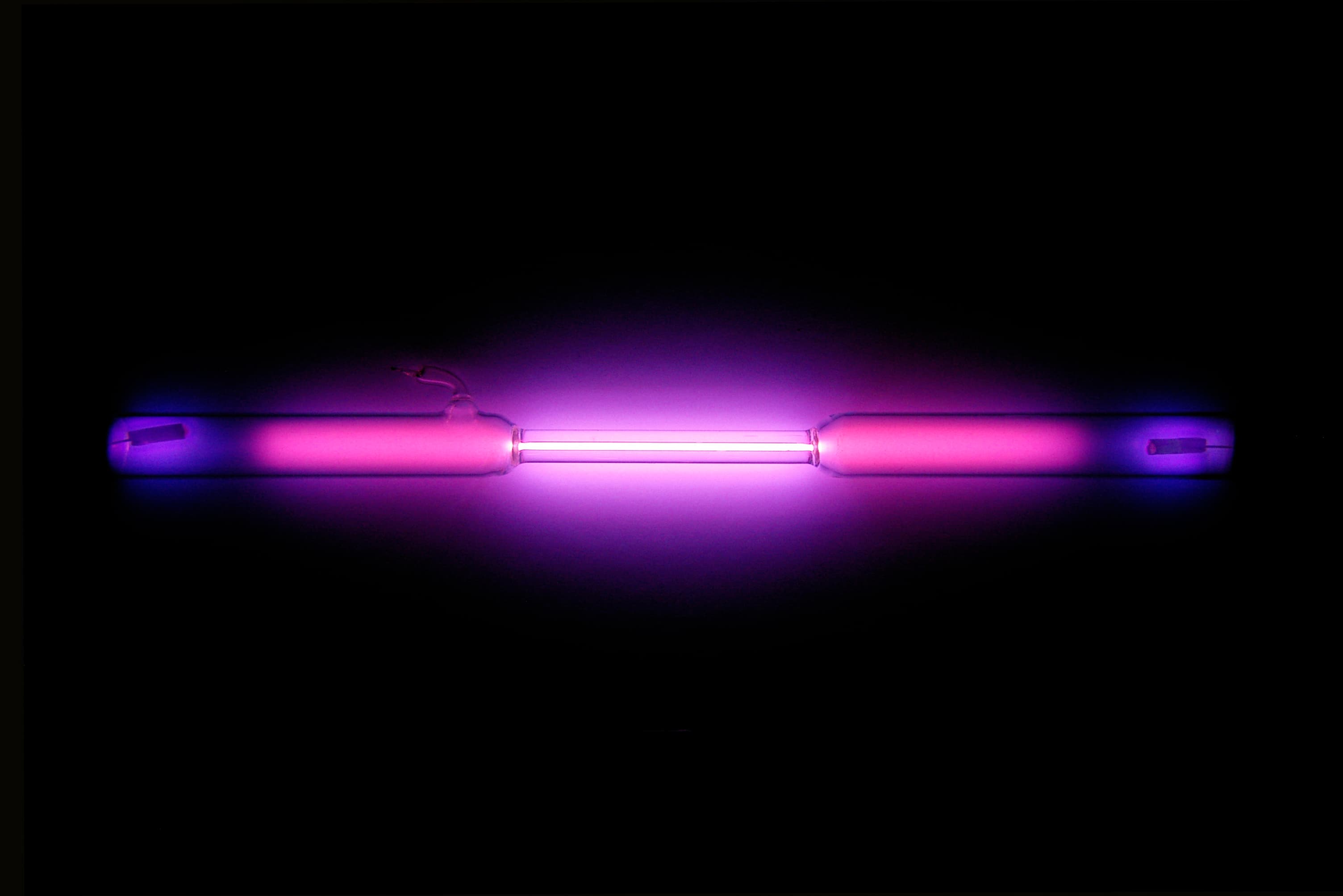 An argon gas discharge tube glowing blue-purple.