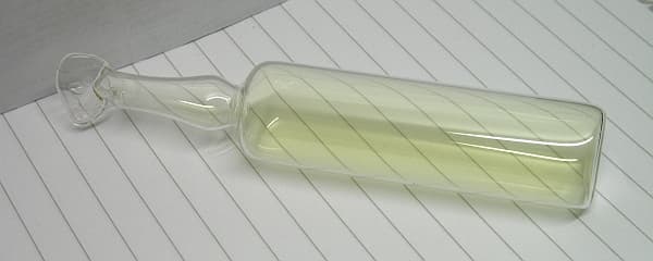 A sealed glass ampoule containing greenish-yellow chlorine gas.