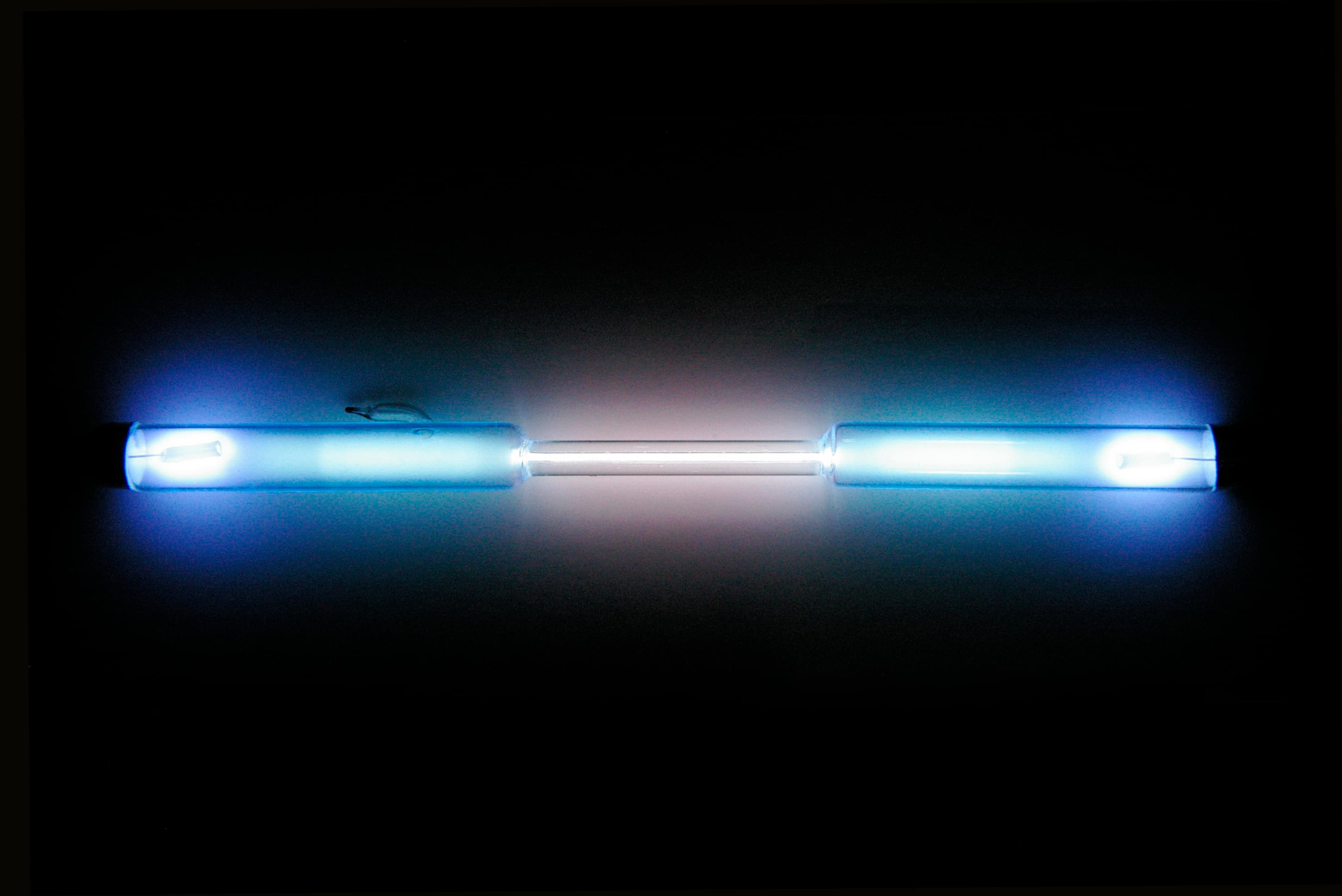 A krypton gas discharge tube glowing pale white-blue.
