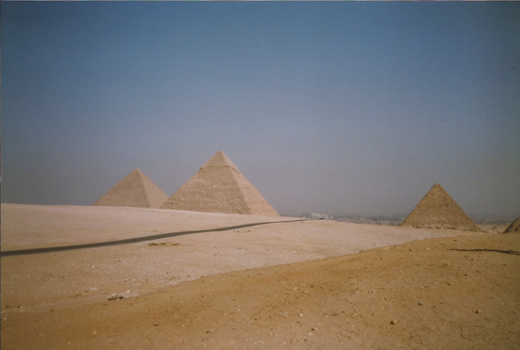 The three main pyramids of Giza rising from the desert plateau in Egypt.