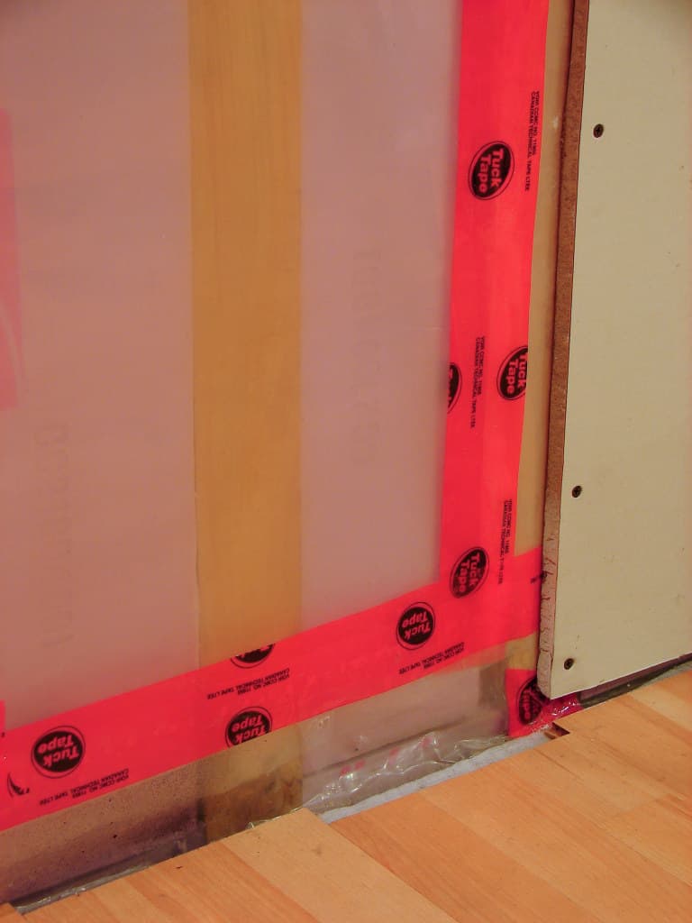 A polyethylene plastic sheet vapor barrier installed between wall insulation and gypsum board.